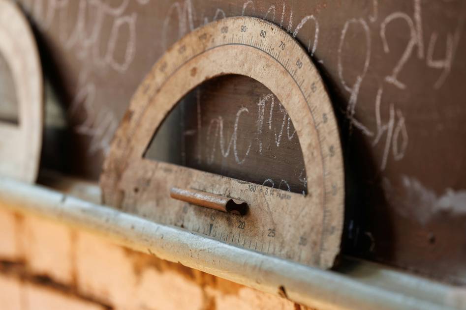 Protractor measuring angles on wooden decor piece